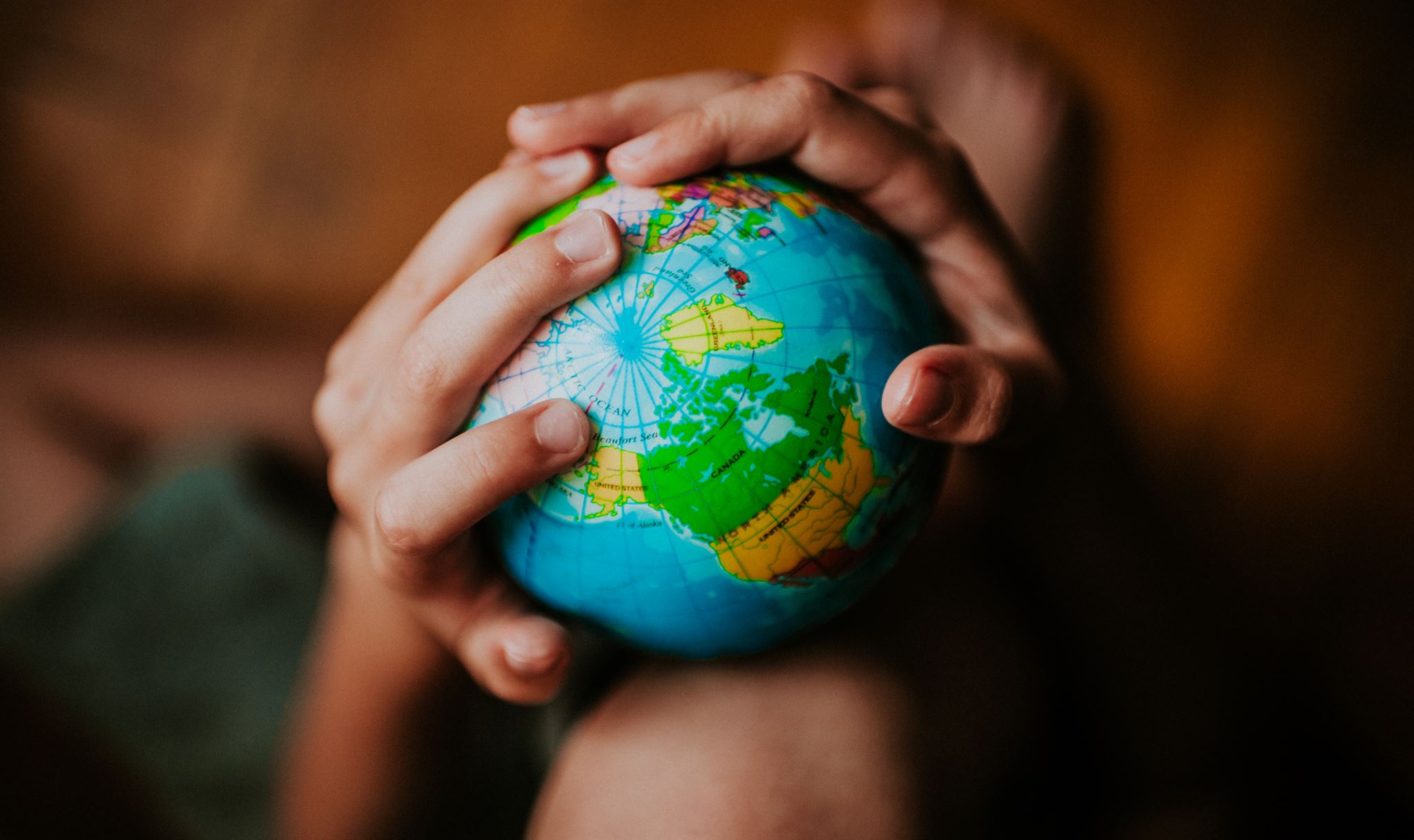 A-person-holding-a-globe